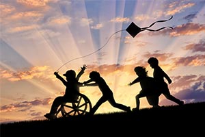 Young disabled people playing on hill