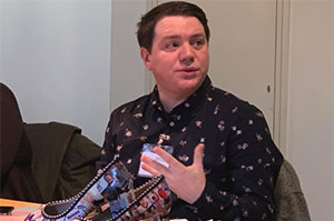 Billy David from Hft steps up to present findings of MP poll at academic conference