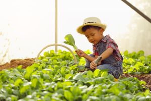 child with adhd gardening outside
