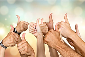 Staff from Adult Day Care Centre with their thumbs up, celebrating success