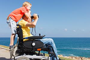 Father and son by the beach enjoying their accessible staycation in Norfolk