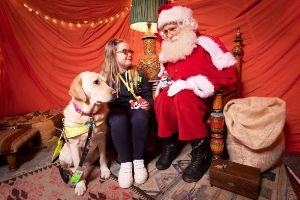 girl with vision impairment and guide dog at christmas grotto
